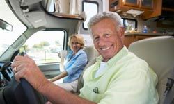 caucasian senior couple in front seat of RV