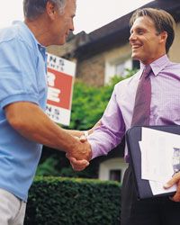 Man shaking hands with real estate agent