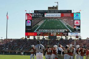 "Godzillatron," seen here in a game between archrivals Texas and Texas A&M on Nov. 24, 2006, looms over the Longhorns football team.”border=