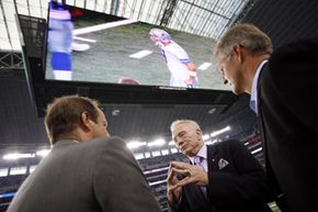 Dallas Cowboys owner Jerry Jones and two other men talk underneath the new giant HDTV in Cowboys Stadium on Aug. 21, 2009.