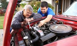 Two men working on classic car