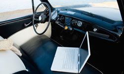 Laptop computer inside classic car