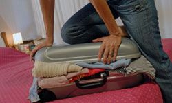 Person traveling with luggage and suitcase.