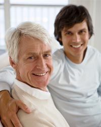 father and son sitting together on couch