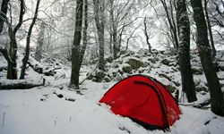 Camping in wintery forest of snow.