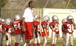 Yes, that's rapper Snoop Dogg coaching the Chino Hills Pop Warner Football Team.