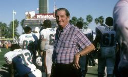 Owner of the Miami Dolphins, Joe Robbie seen on the sidelines during an NFL football game at Joe Robbie Stadium in Miami, Florida in the early 1980's.