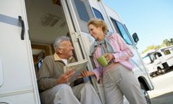 Retired couple with map by RV