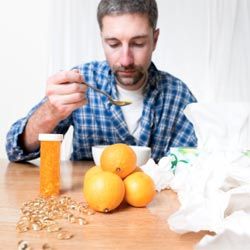 man with a cold eating soup