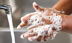 close-up of soapy hands and faucet
