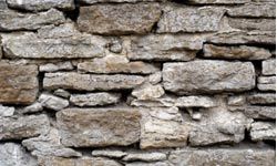 Fieldstones can make a garden wall look rugged and charming.