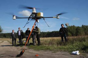Journalists watch a quadrocopter drone with a device for marking telephone cables with artificial DNA take off in 2013. Deutsche Telekom is releasing drones across Germany to fight cable theft, which has shot up with the increasing value of copper.