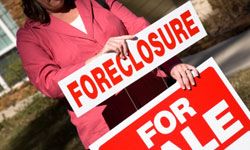 Putting foreclosure sign on for sale sign