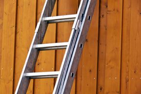 A ladder leaning on a wall.