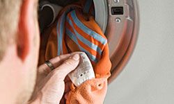 man loading washing machine