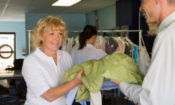 man picking up dry cleaning