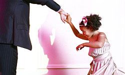 child dancing with father