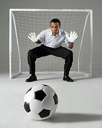 Businessman defending soccer goal