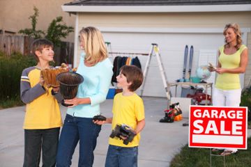 Happy customers leaving a Garage Sale with their treasures.