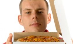 man smelling pizza