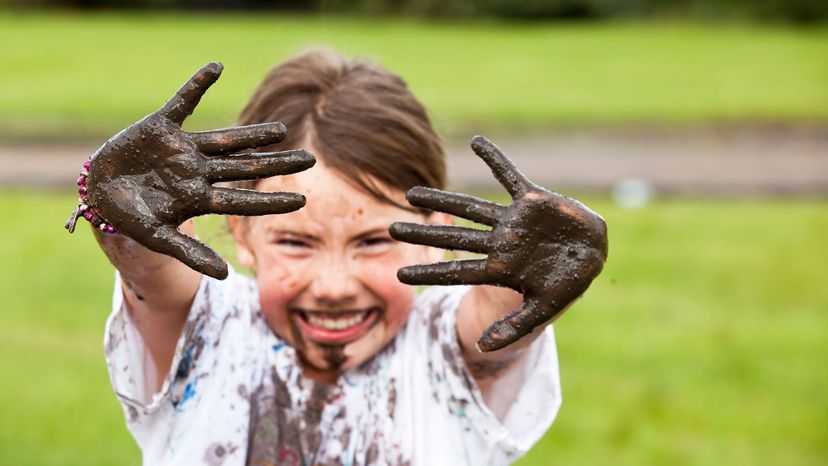 girl playing in mud