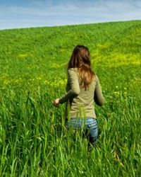 woman running in field of grass