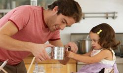 father and daughter cooking