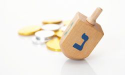 Dreidels are used in a traditional game that has become a fun part of Hanukkah tradition.