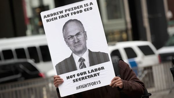 Fight for $15 worker protests the nomination of Andy Puzder for labor secretary on January 26, 2017, in Chicago, Illinois.