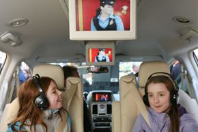 Willa Norris, 8, left, and Hannah Fowler, 10, sit in a 2008 Chrysler Town and Country minivan during a demonstration of Sirius Backseat TV.