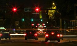 Cars at red traffic light at night
