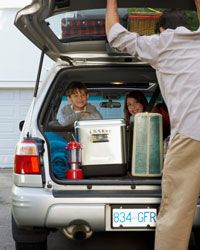 Man packing family car trunk for vacation