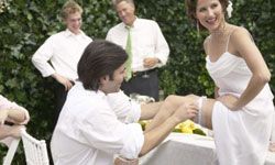 groom taking off bride's garter