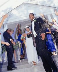 just-married couple being showered with rice