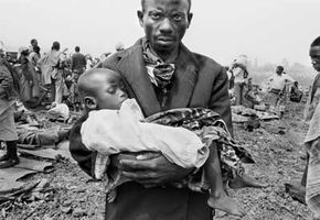 A father cradles his sick child during the cholera outbreak in 1994 that claimed thousands of lives in Goma, Zaire. Cholera is a diarrhea-causing illness contracted by consuming water or food contaminated with V. cholerae bacteria.