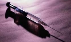 Syringe filled with narcotic medicine in healthcare setting.