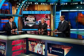 ESPN is all sports, all the time. Here, host Rece Davis talks college football with analysts Lou Holtz and Mark May in 2008.