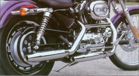 A cast 16-inch rear wheel and spoke 21-inch front wheel are featured on the 2002 Harley-Davidson XL-1200C Sportster.