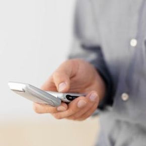 close-up of man's hand dialing cellphone