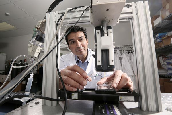 Scientist with his bioprinter