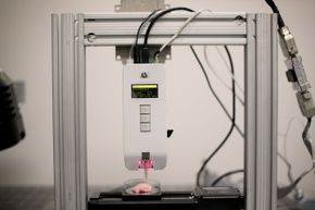 This bioprinter, located at the Shiley Center for Orthopedic Research & Education at Scripps Clinic in La Jolla, Calif., is displaying the temperature, pressure and drops/nozzle settings just above the three buttons. Could a future organ of yours be created on a bioprinter someday?”border=