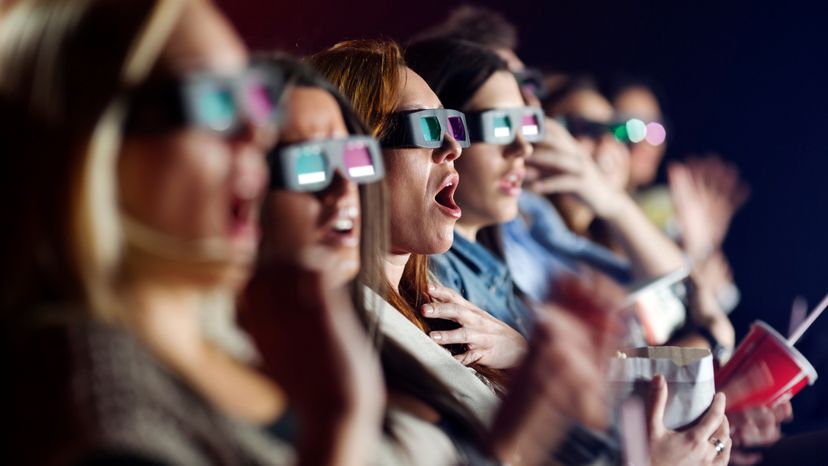 An audience watching a 3D movie with 3D glasses on. 