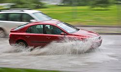 Vehicles pass through a flooded street during heavy rain in Santiago, Chile.