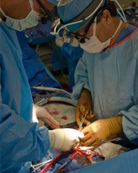 Doctors perform heart bypass surgery.
