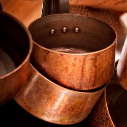 Copper pots that need a good cleaning.