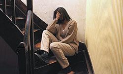 upset woman sitting on steps