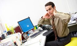 man works abs on exercise ball at work