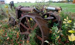 An antique tractor sits in Fred Webster's yard, part of his 1,500-piece collection of antique farm equipment in Coventry, Vt.