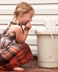 young girl leaning over ice cream maker