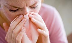 woman sneezes